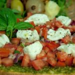 Bruschette gourmet colorate con ingredienti freschi e creativi su un tavolo di legno.