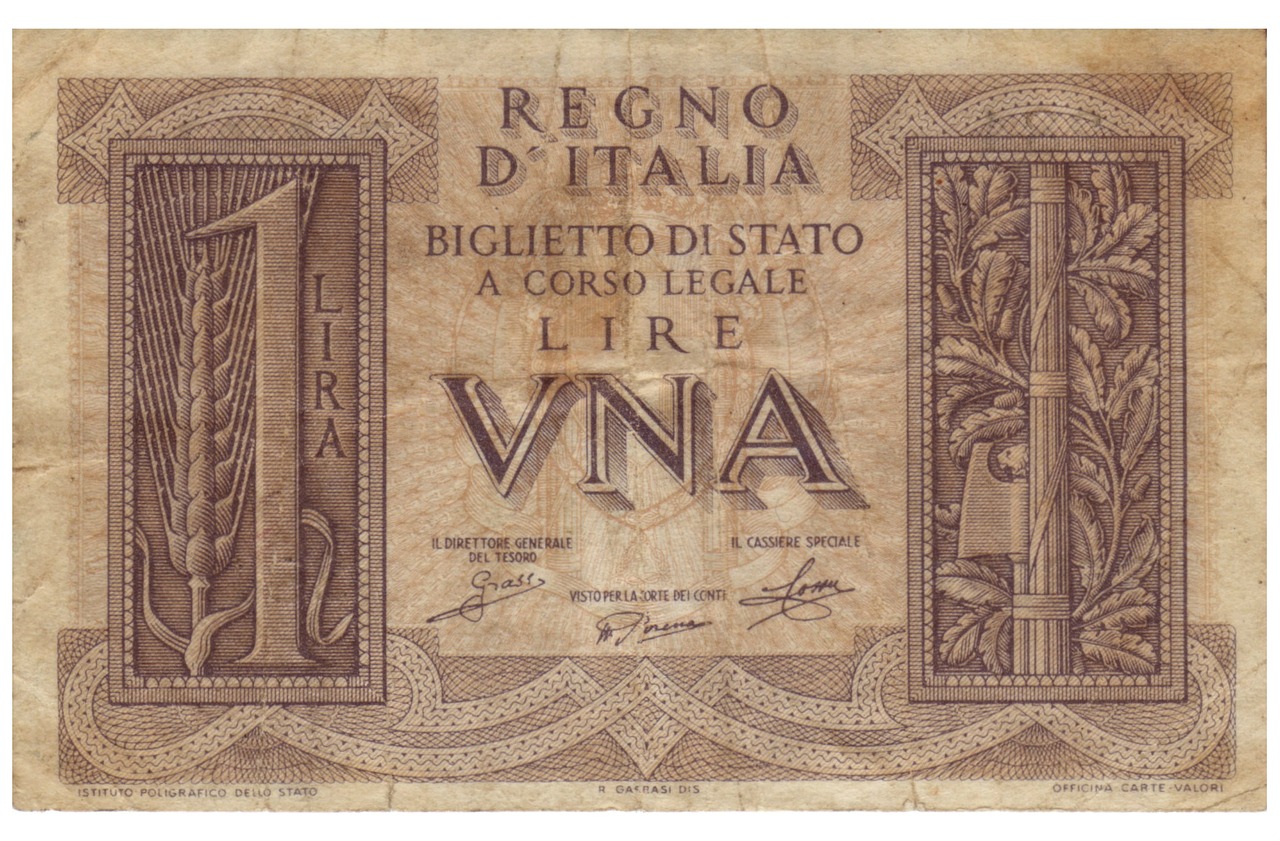 Moneta da 5 lire del 1954 con spiga, esposta per valutazione e collezionismo.